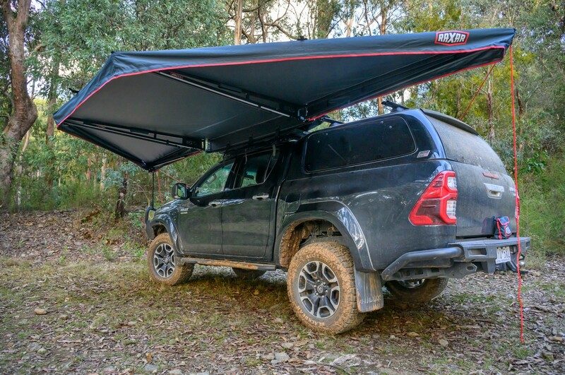 Rear of a Toyota HiLux with canopy, rear bar and awning at a bush campsite