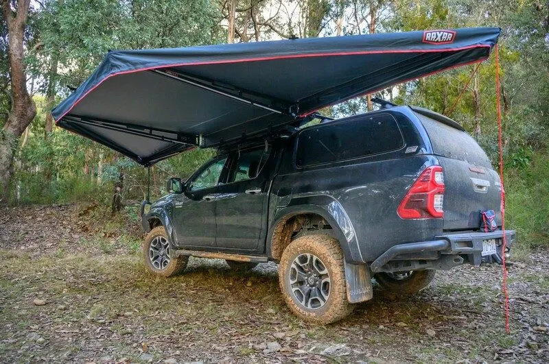 Rear of a Toyota HiLux with canopy, rear bar and awning at a bush campsite