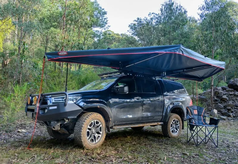 HiLux with a Raxar 180 awning and camp chairs at a bush campsite